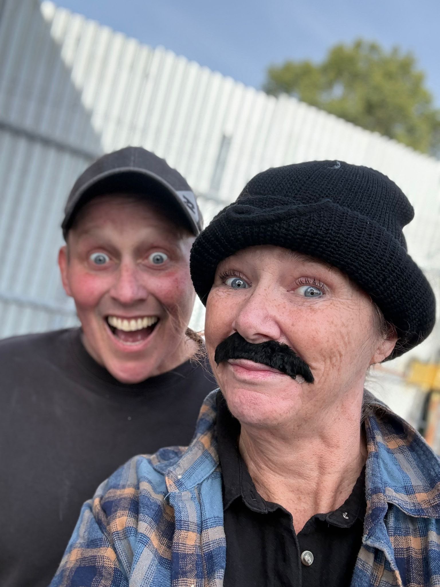 Cast members in costume and moustache