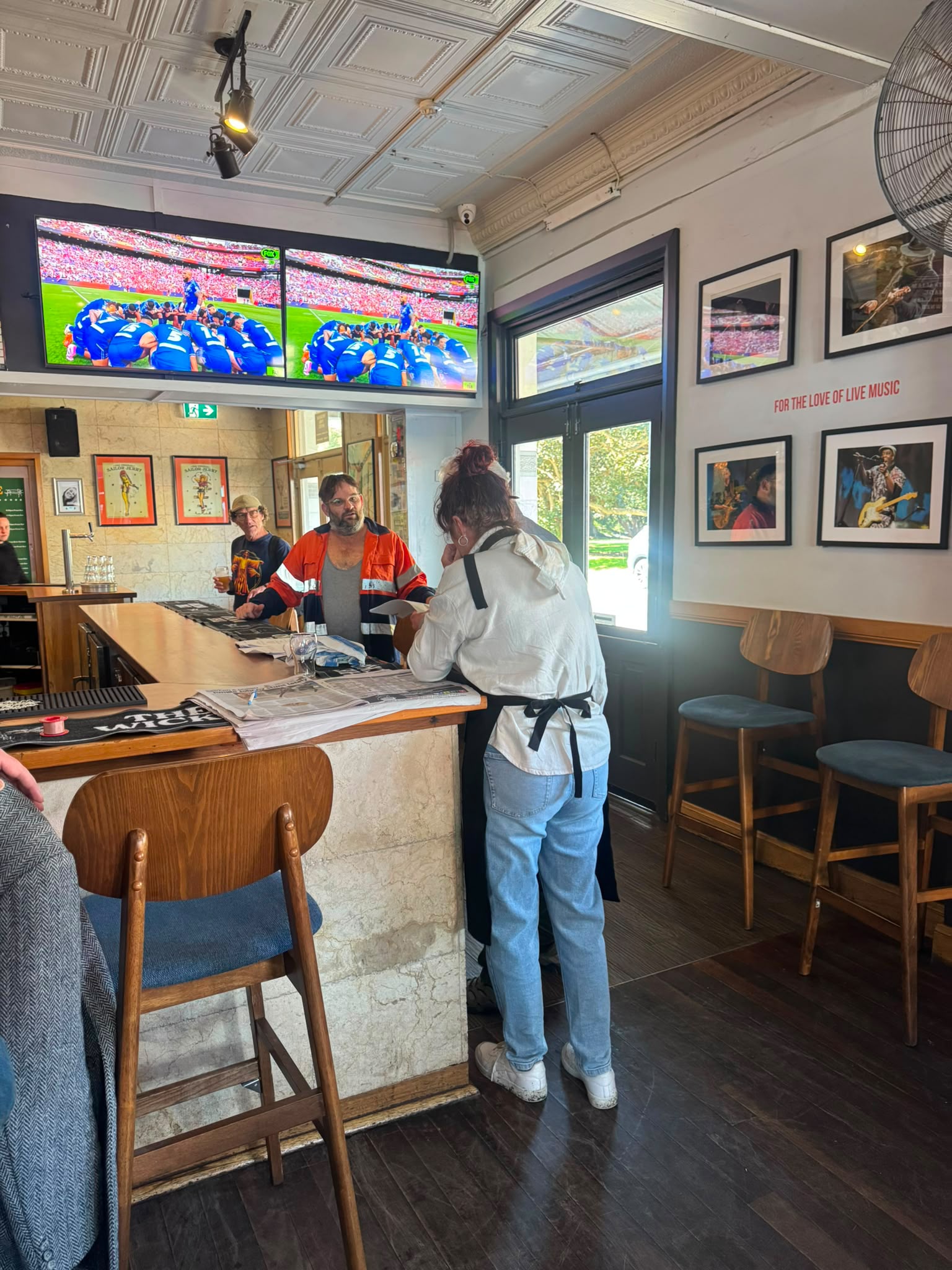 Cast and crew filming a pub scene