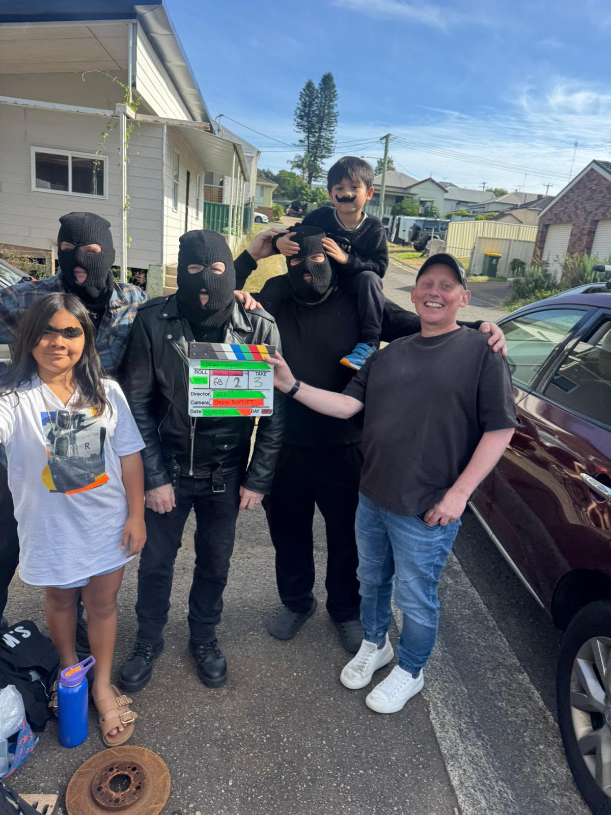 Cast in costume on set with the clapperboard