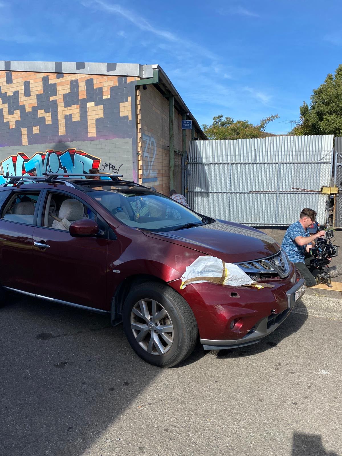 Crew filming a car scene on location
